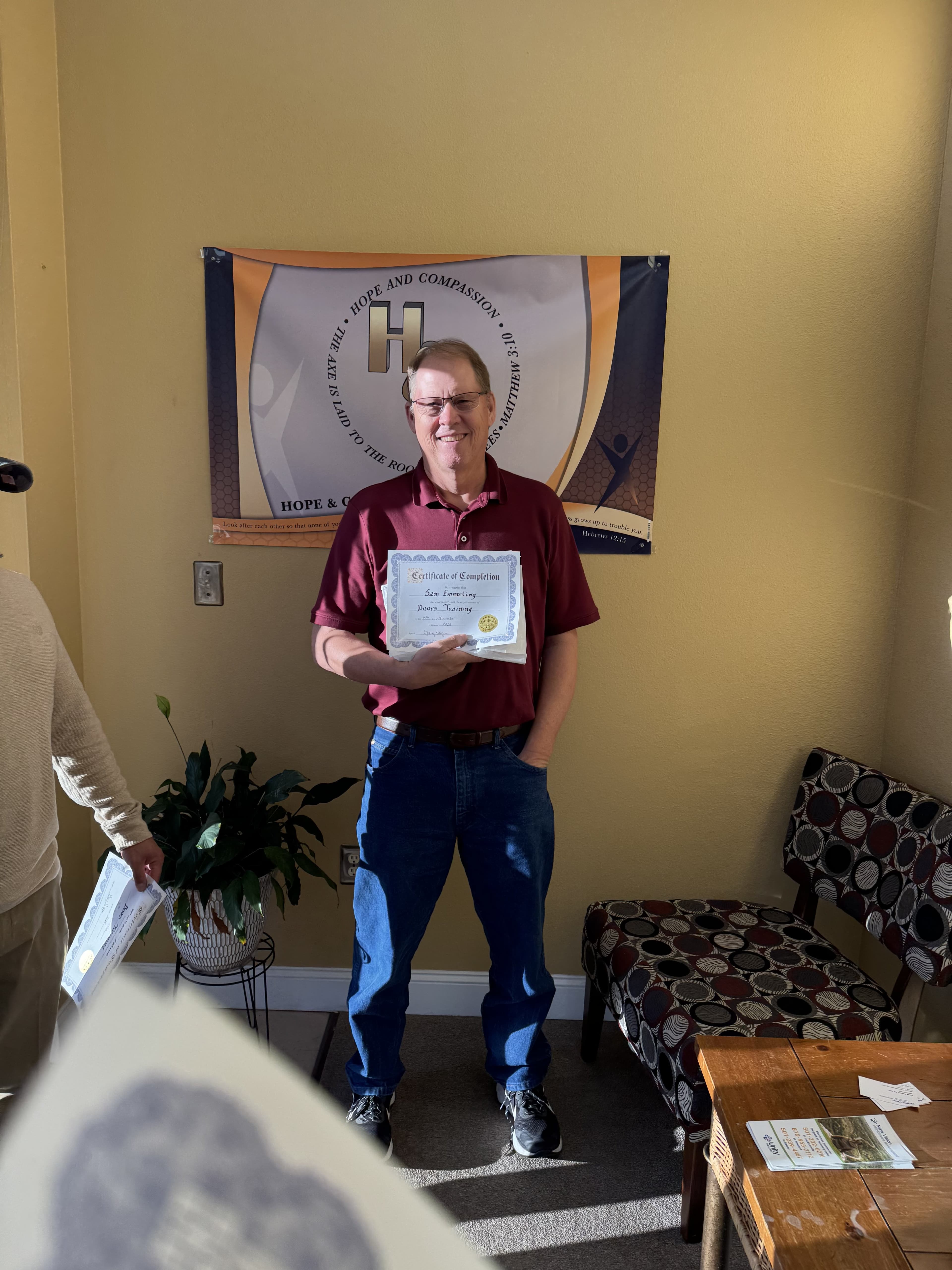 Program graduate holding a completion certificate